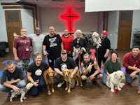 a group of people and dogs posing for a photo