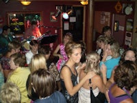 a group of people dancing in a bar