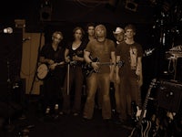 a group of people standing in front of a microphone
