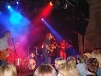 a group of people on stage at a concert