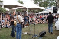 a group of people standing on stage in front of a crowd
