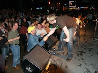 a man standing on a stage in front of a crowd